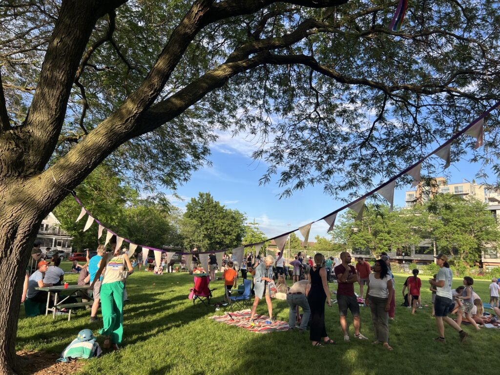 party in park with banner in tree